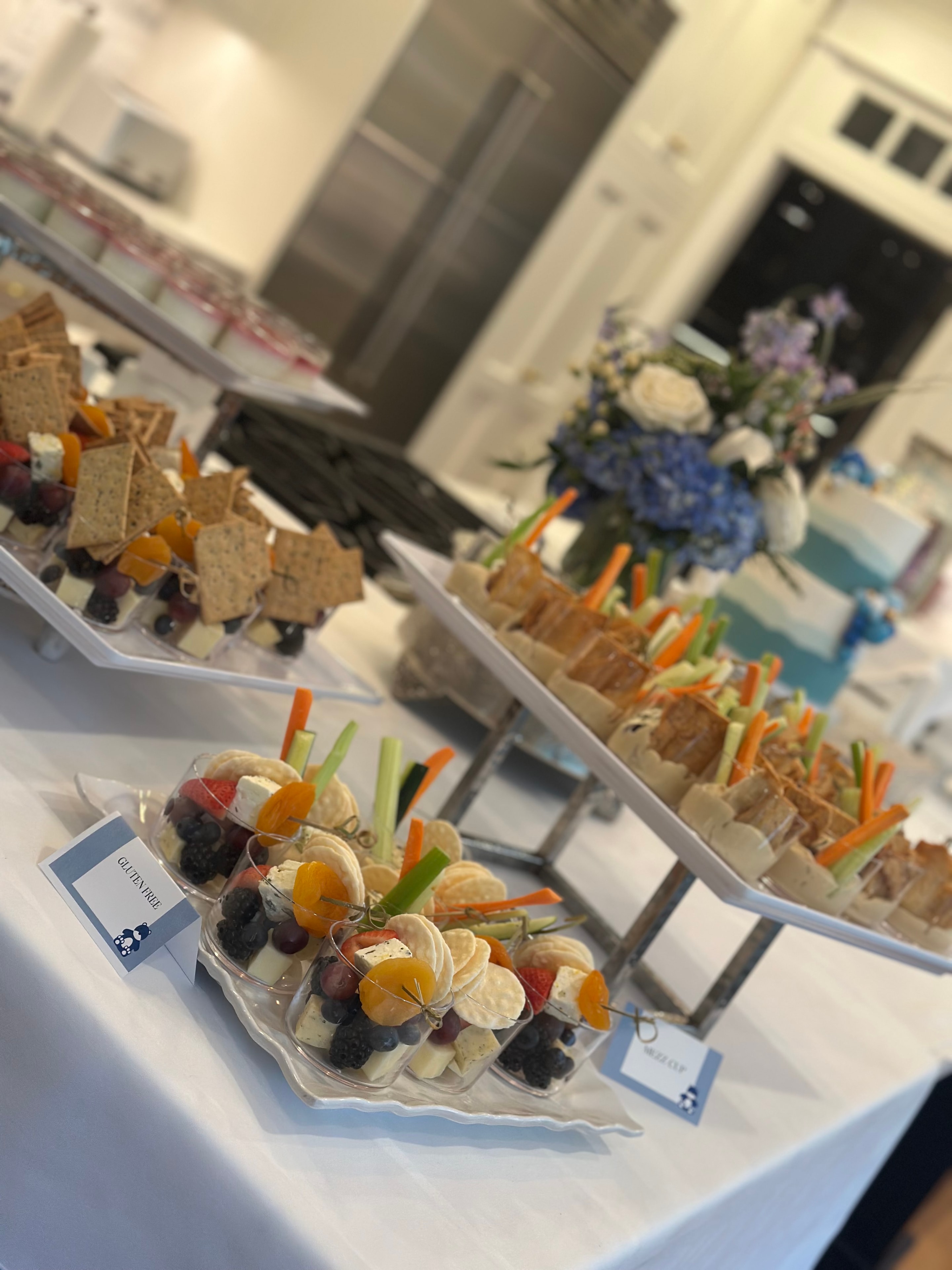 Beautifully arranged individual appetizer boxes with fruit, cheese, and vegetables